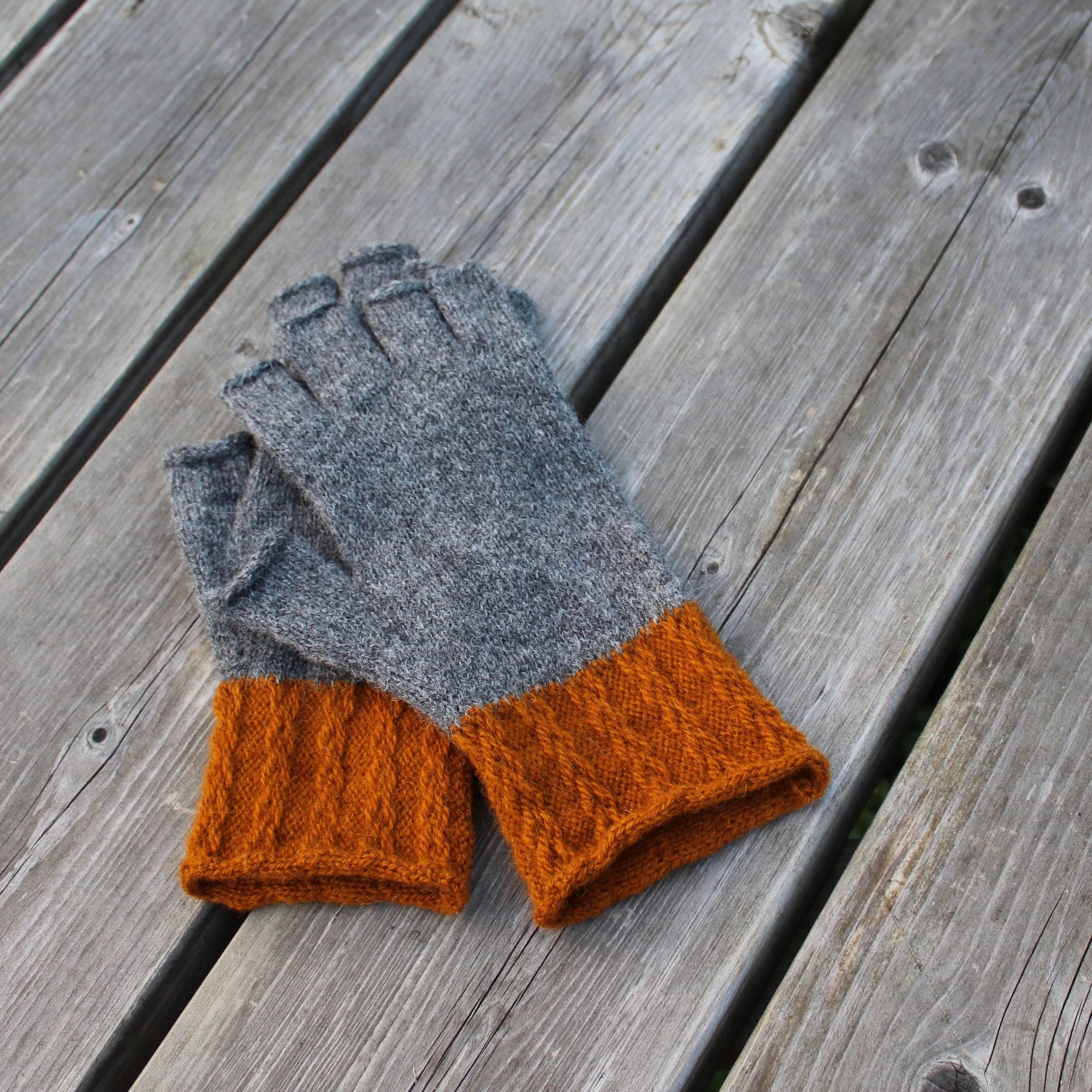 Gray and orange gloves on a wooden surface