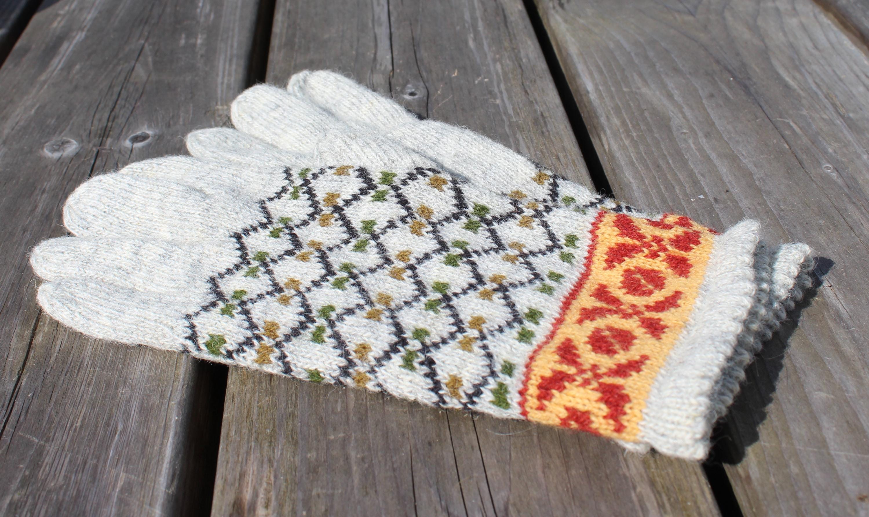 Knitted glove with a pattern on a wooden surface