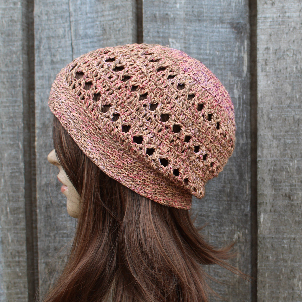 orange brown crochet hat worn by a person against a wooden background