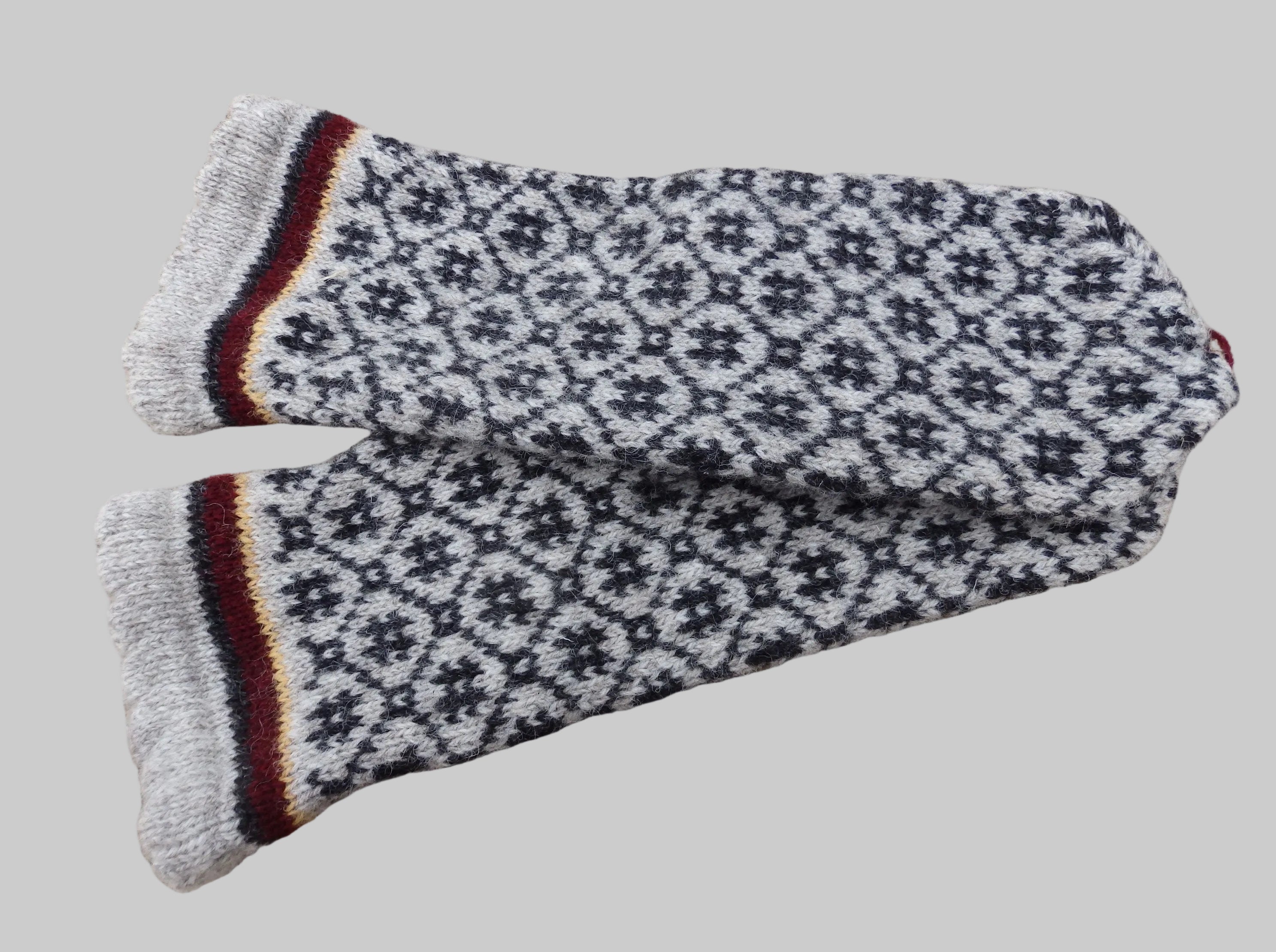 Pair of patterned gloves on a textured fabric background