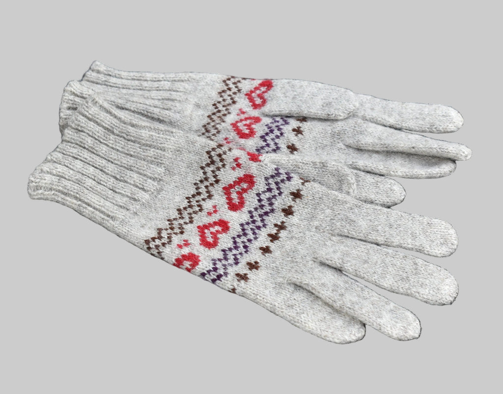 White gloves with red heart pattern on a black background