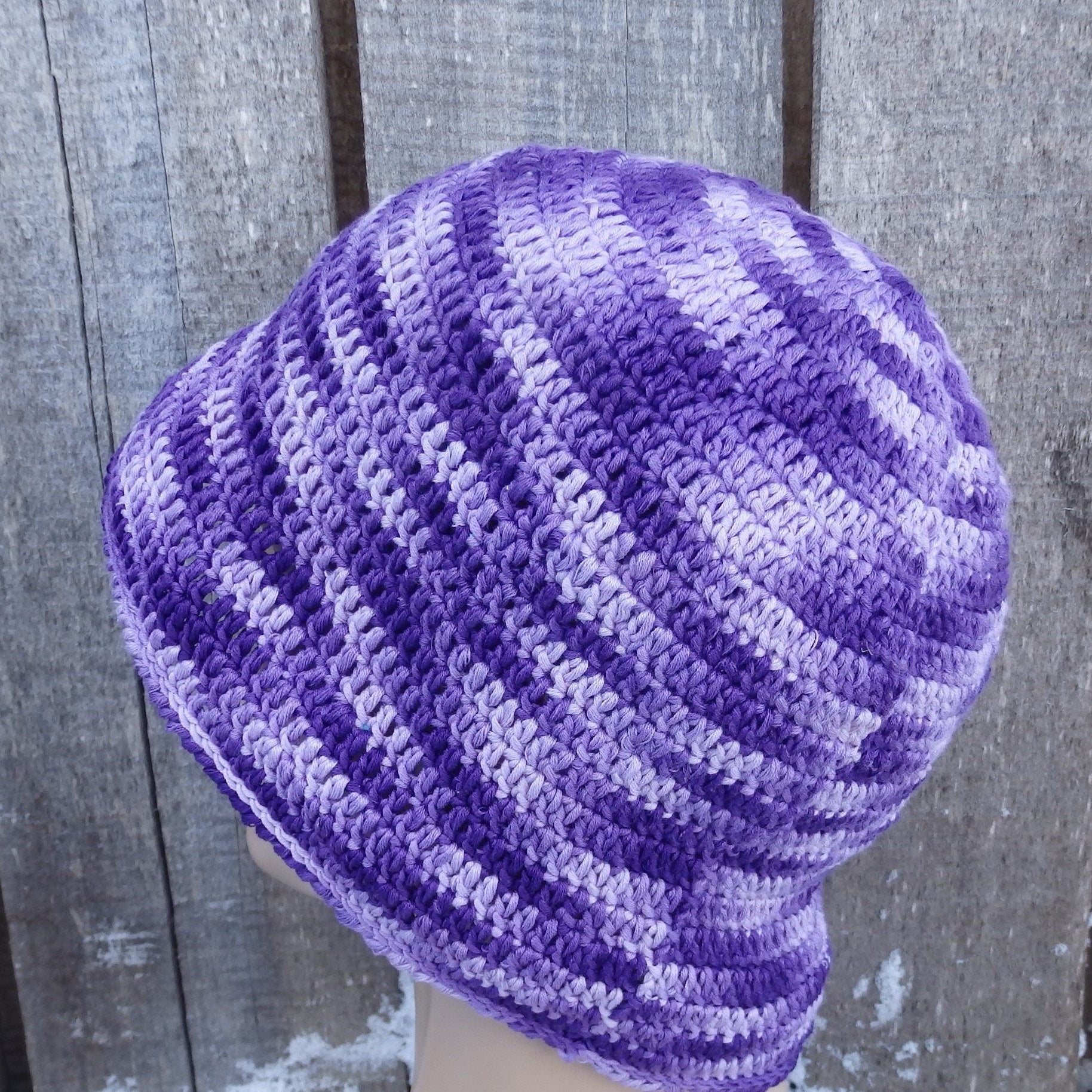 Purple cotton panama hat on a wooden background