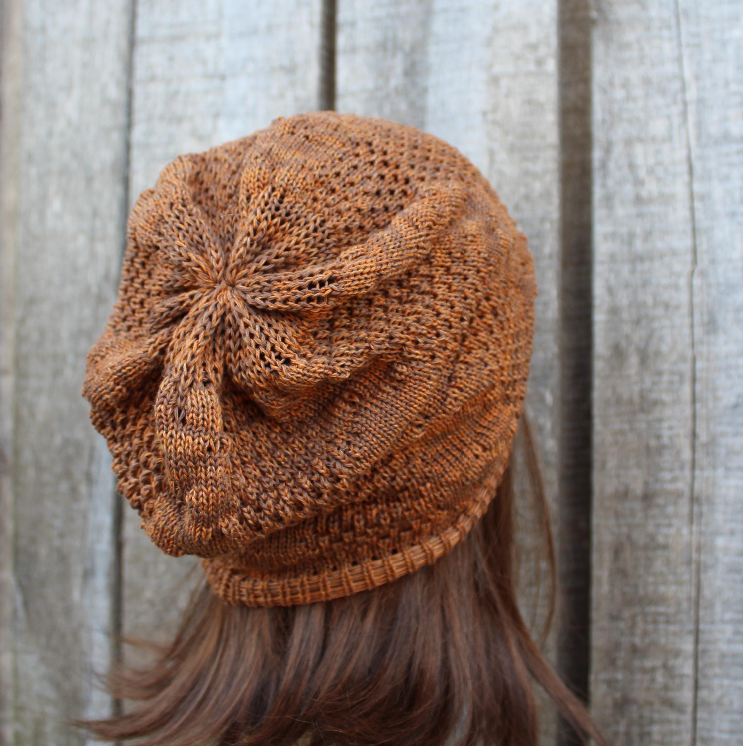 Brown knitted beanie on a mannequin head against a wooden background