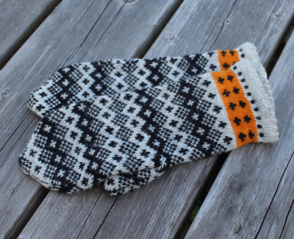 Knitted glove with a geometric pattern on a wooden surface