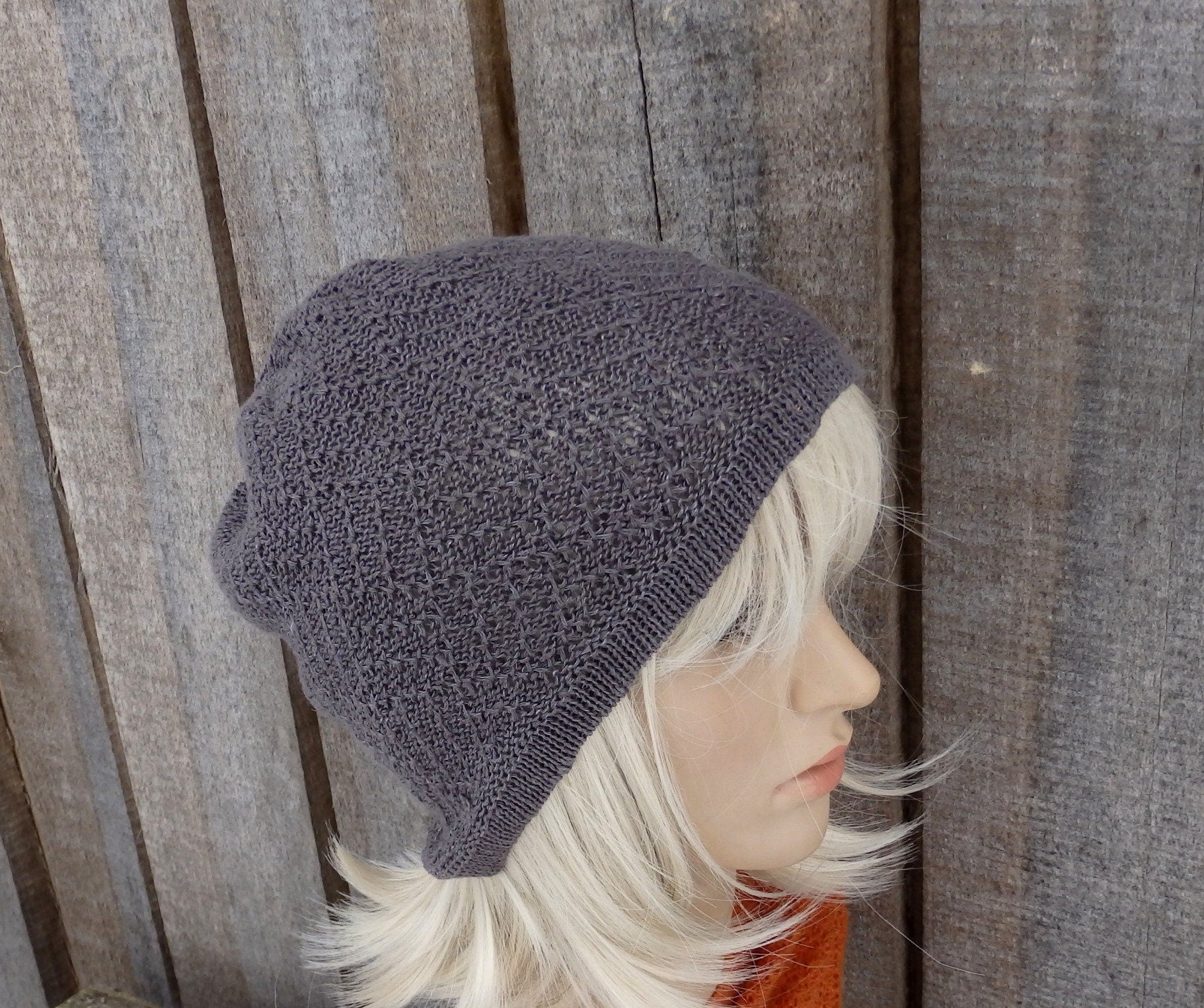 Gray knit beanie on a mannequin head against a wooden background