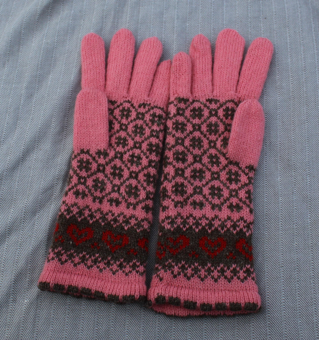 Pair of pink gloves with a black and red pattern on a gray fabric background