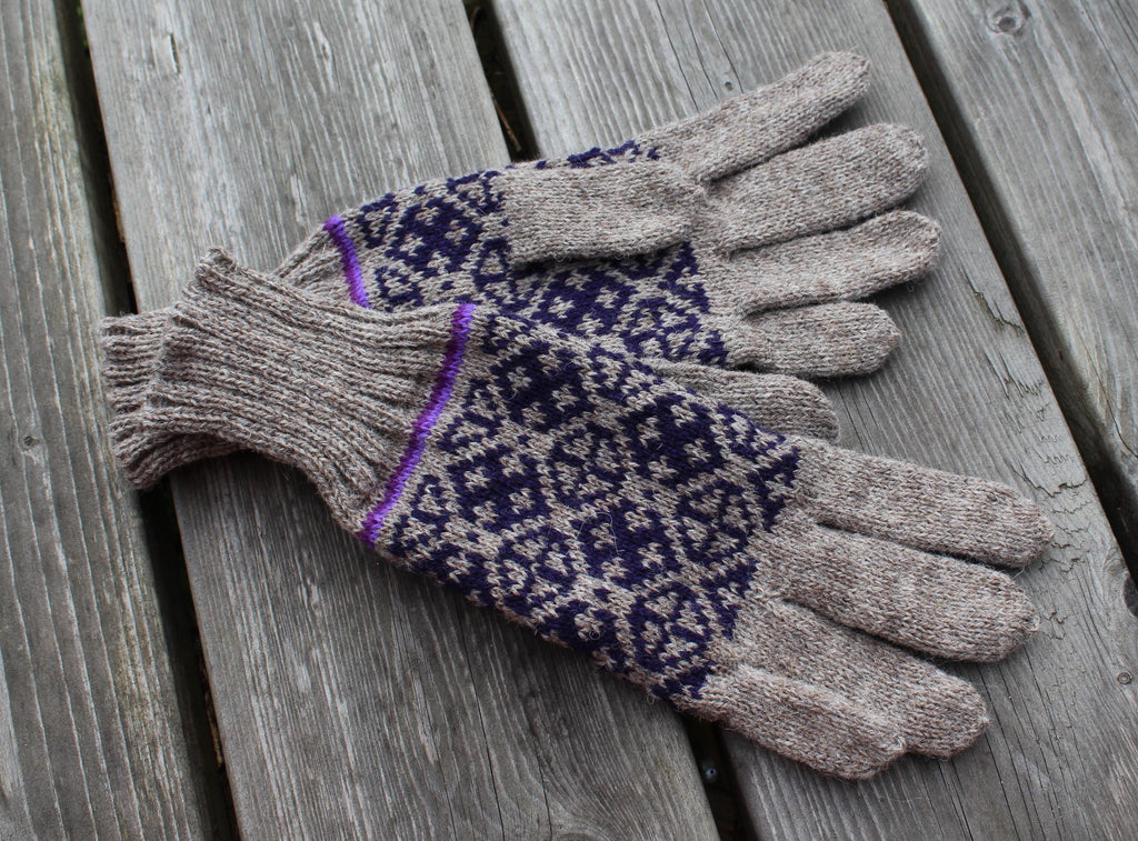 Pair of gloves with a pattern on a wooden surface