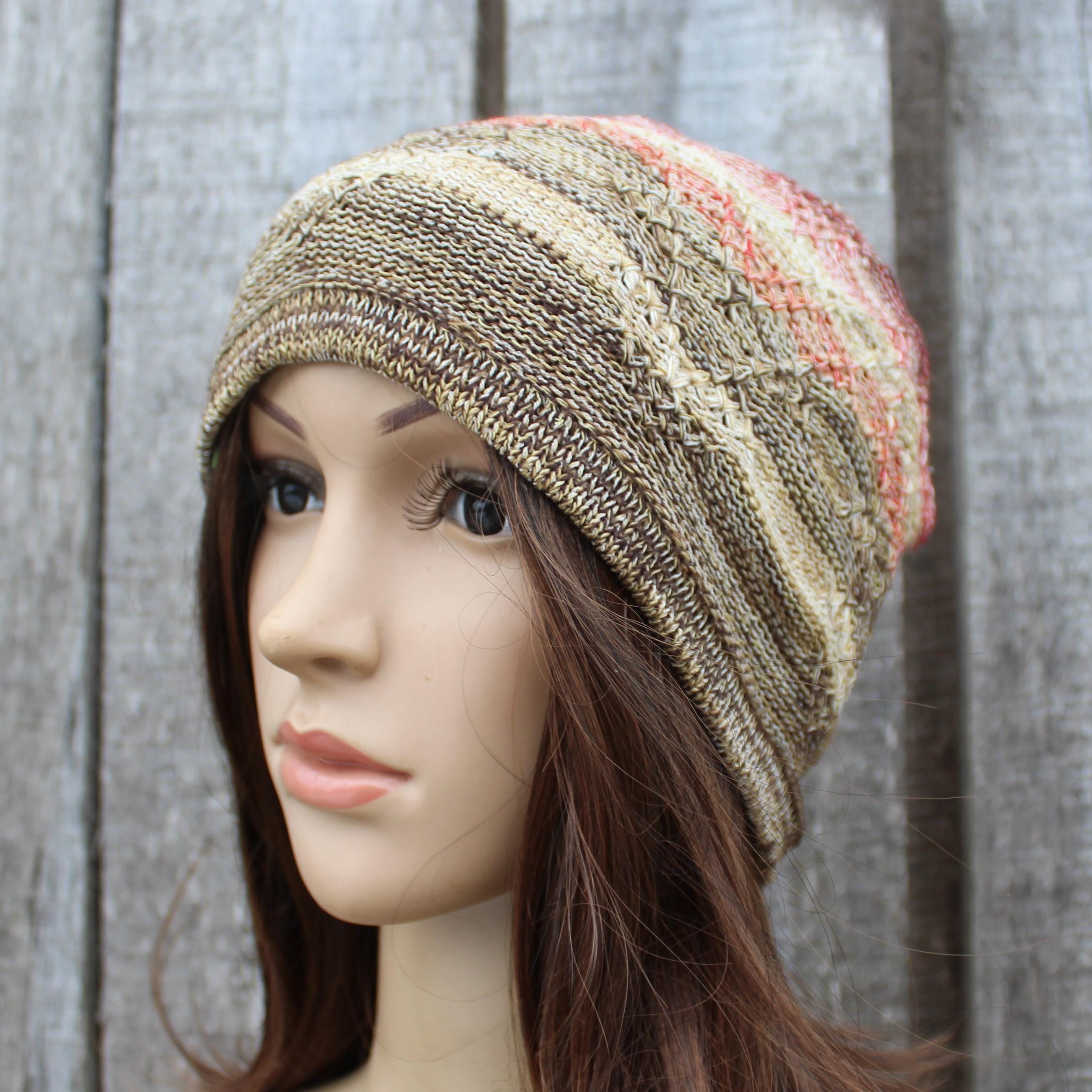 Knitted beanie on a mannequin head against a wooden background