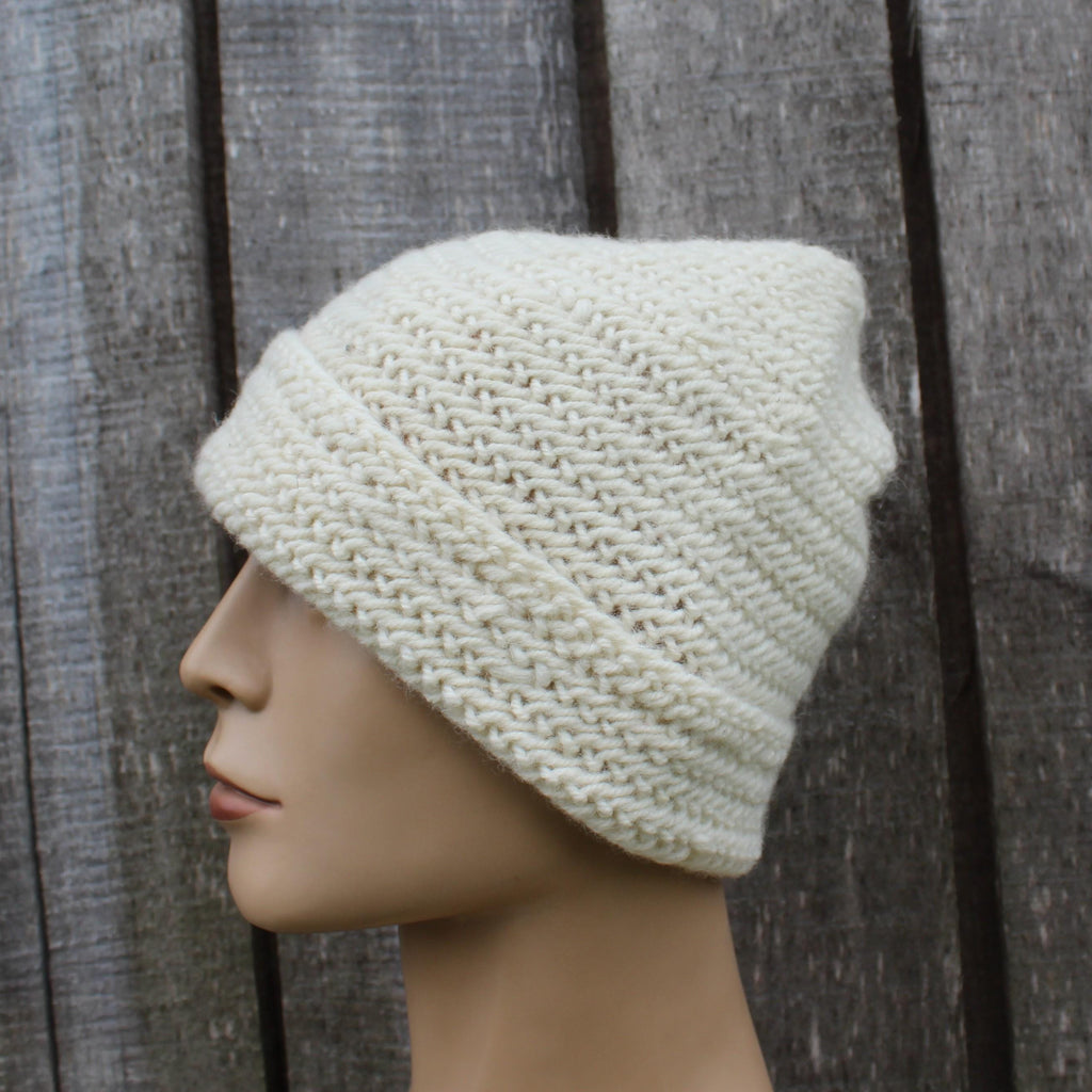 naalbinding beanie on a mannequin head against a wooden background