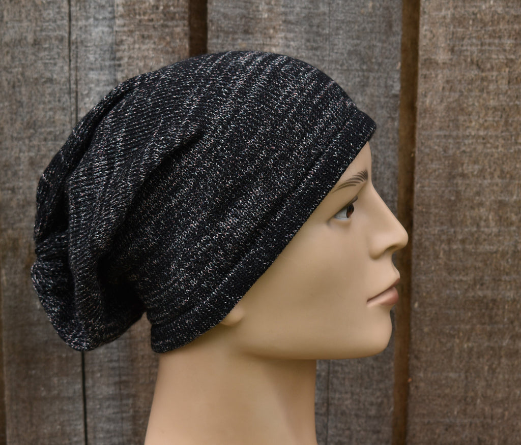 Black knit beanie on a mannequin head against a wooden background