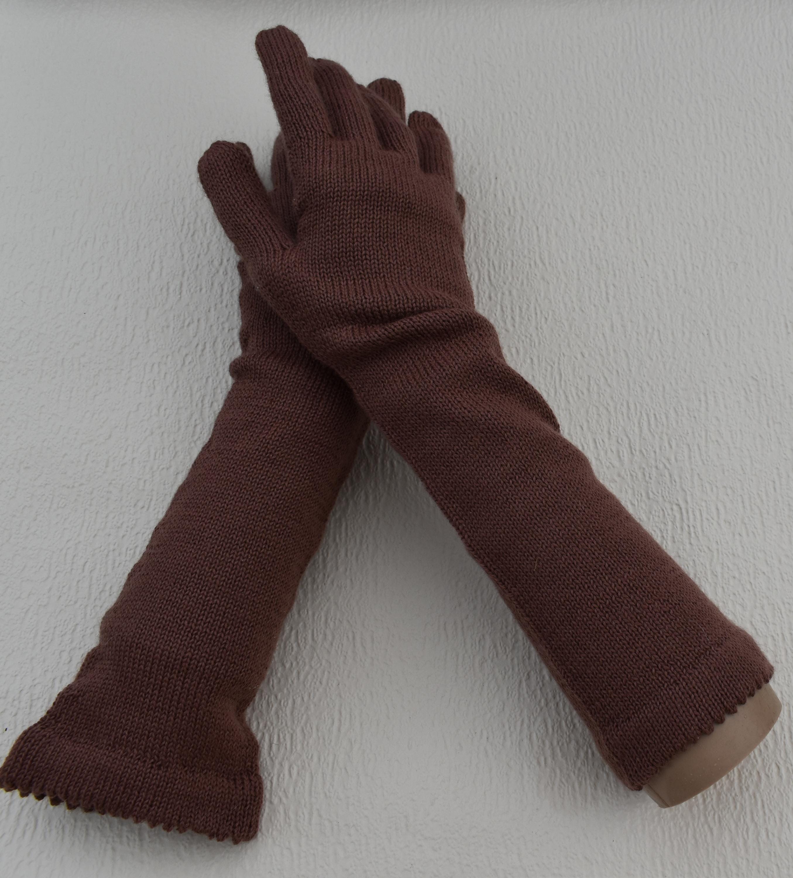 Pair of brown gloves on a light gray background