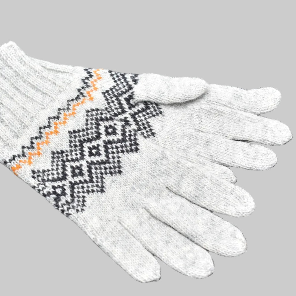 Gray knitted glove with a pattern on a black background