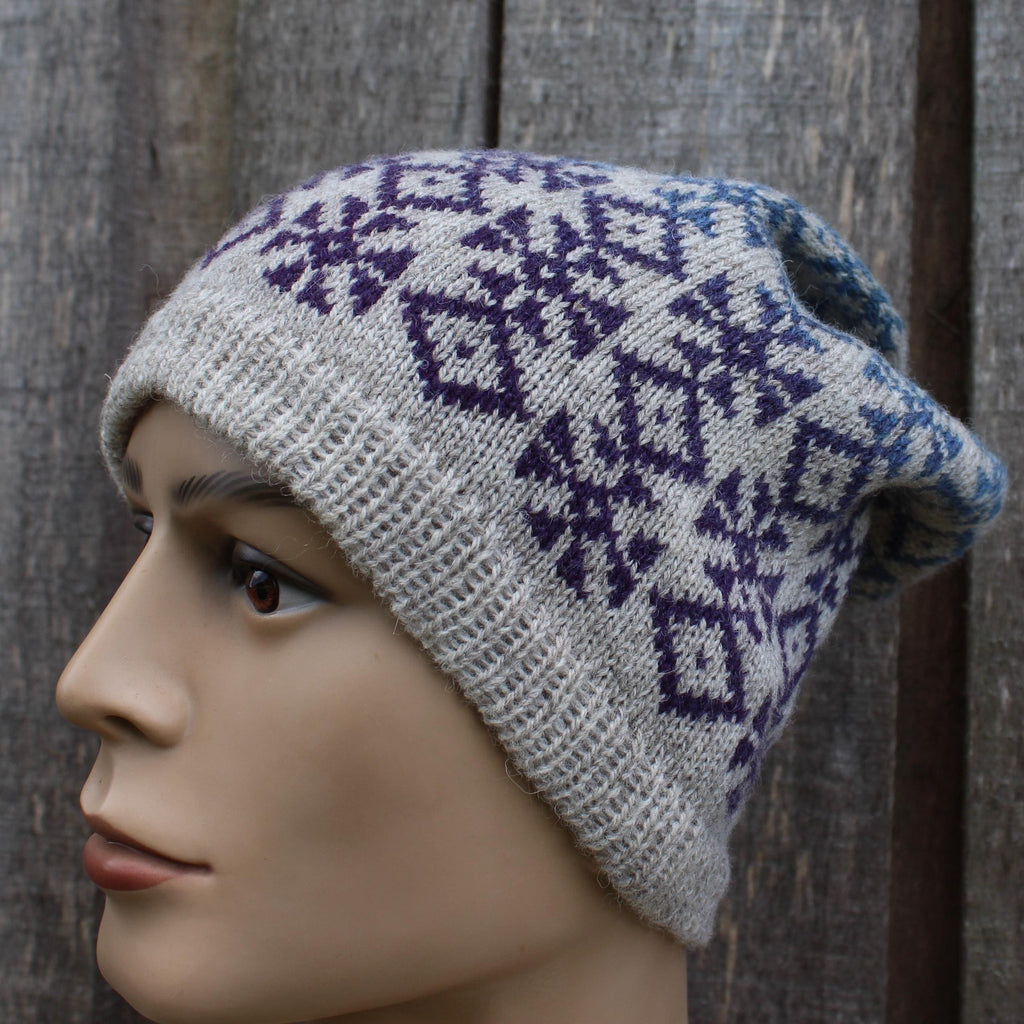 Knitted hat with a pattern on a mannequin head against a wooden background