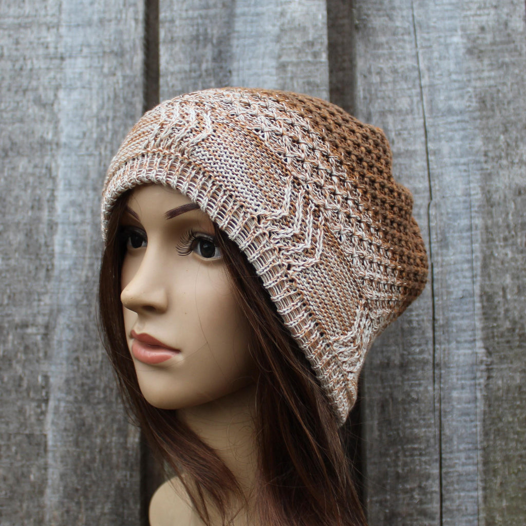 Knitted beanie on a mannequin head against a wooden background