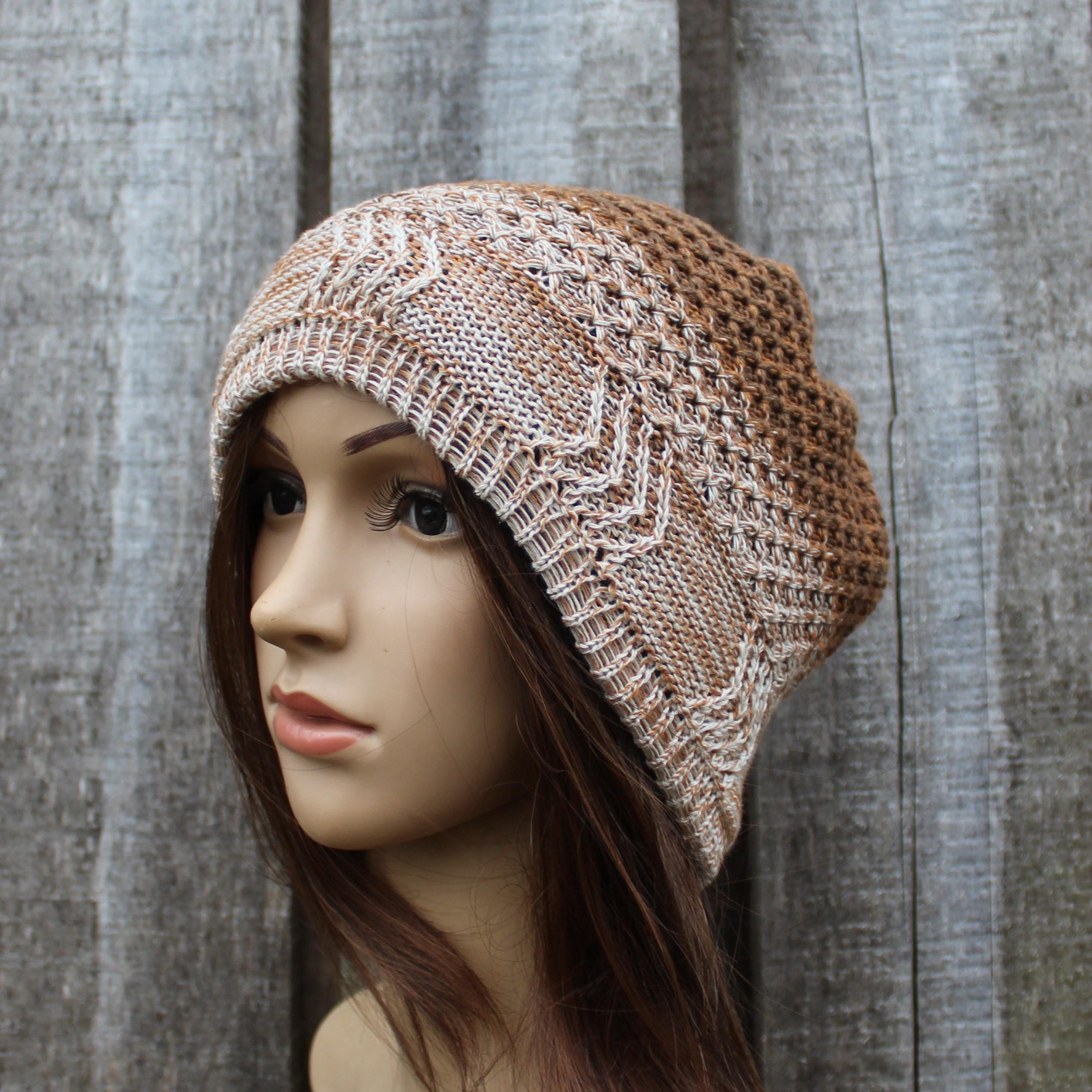 Knitted beanie on a mannequin head against a wooden background