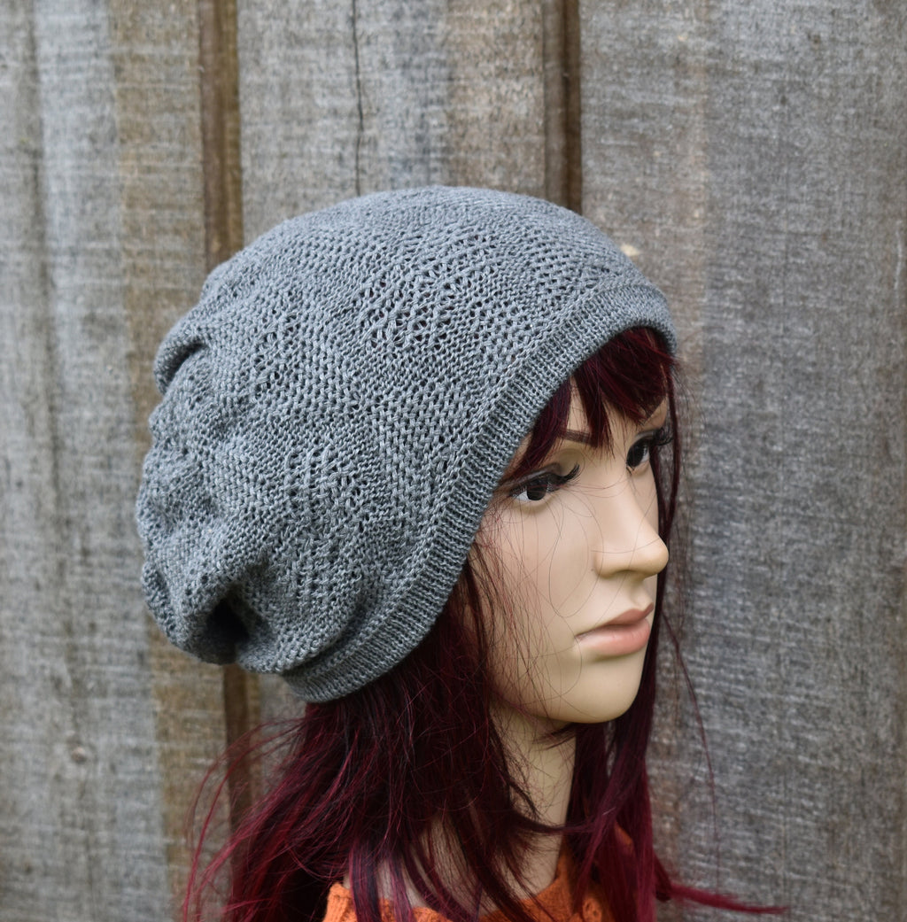 Gray knit beanie on a mannequin head against a wooden background