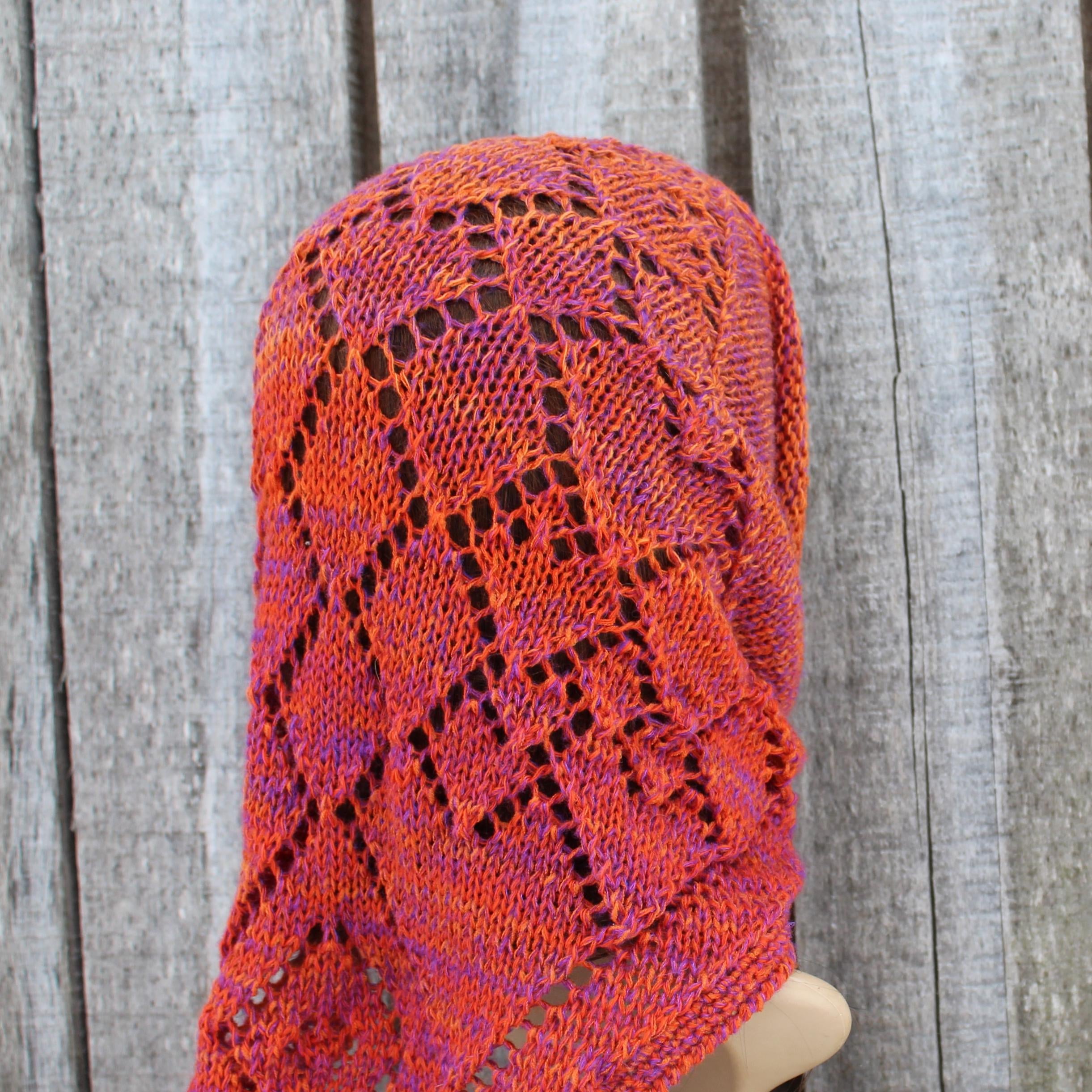 Knitted hat with a geometric pattern on a wooden background