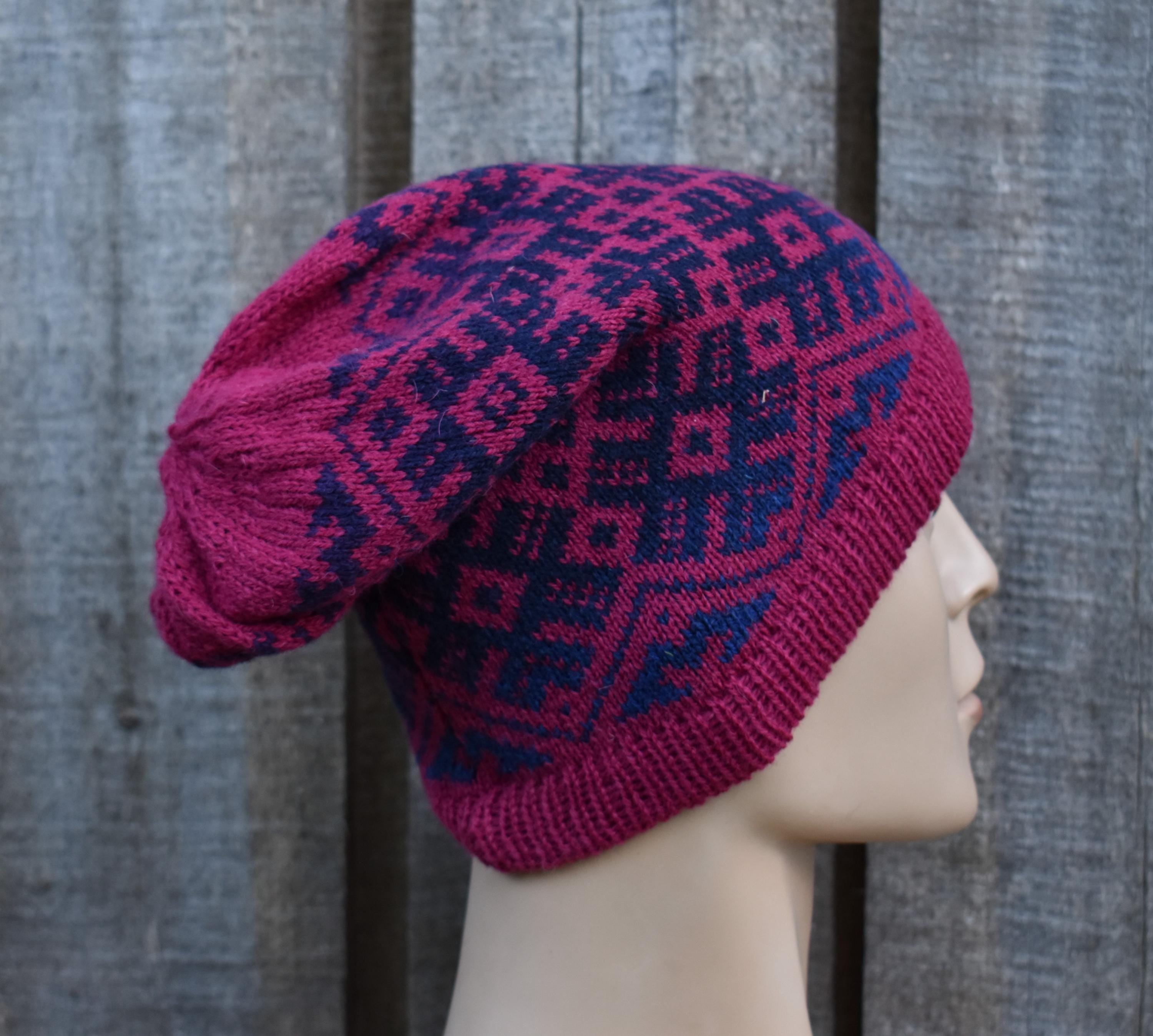 Knitted hat with geometric pattern on a mannequin head against a wooden background