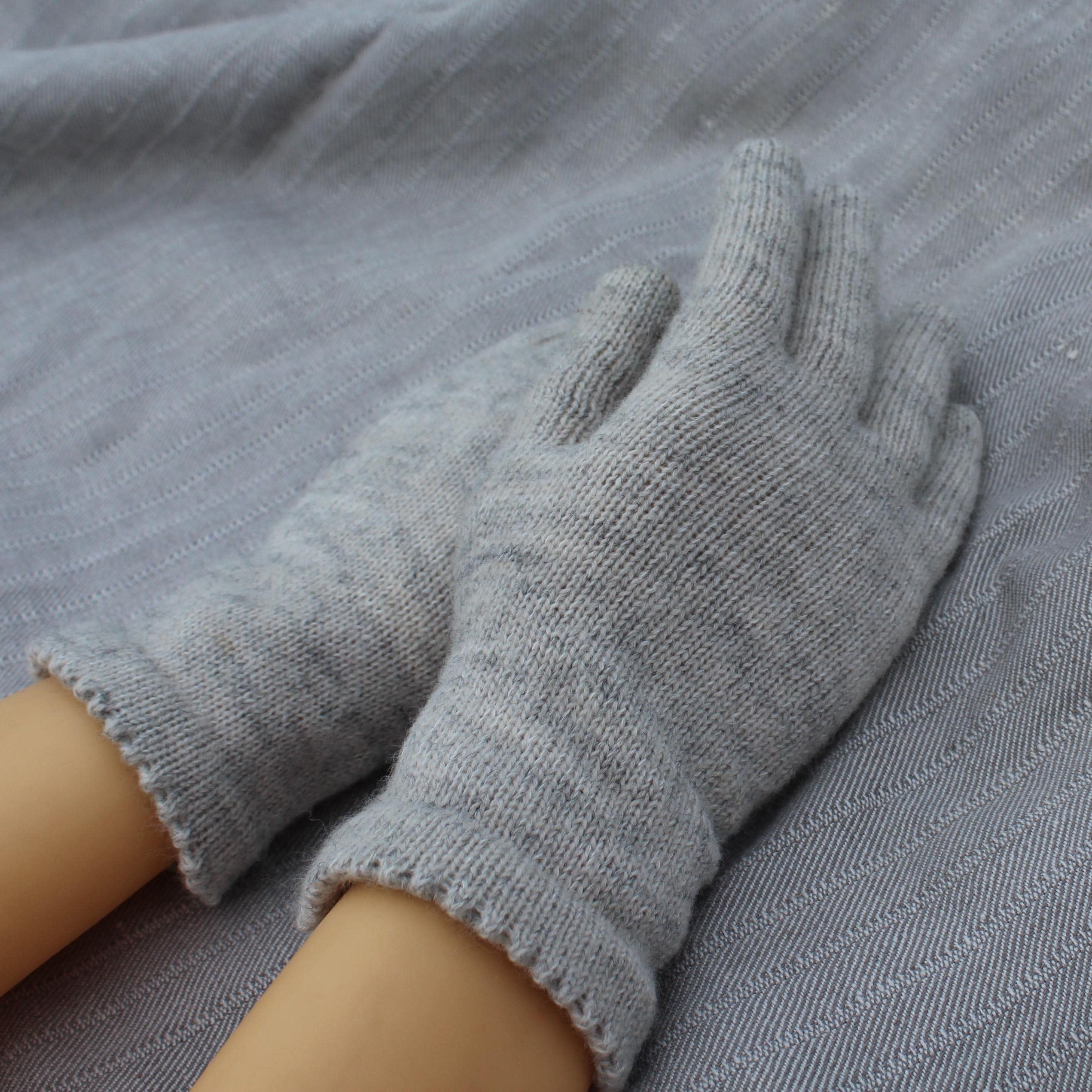 Gray gloves on a gray fabric background