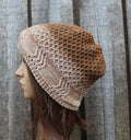 Knitted brown and beige hat on a mannequin head against a wooden background