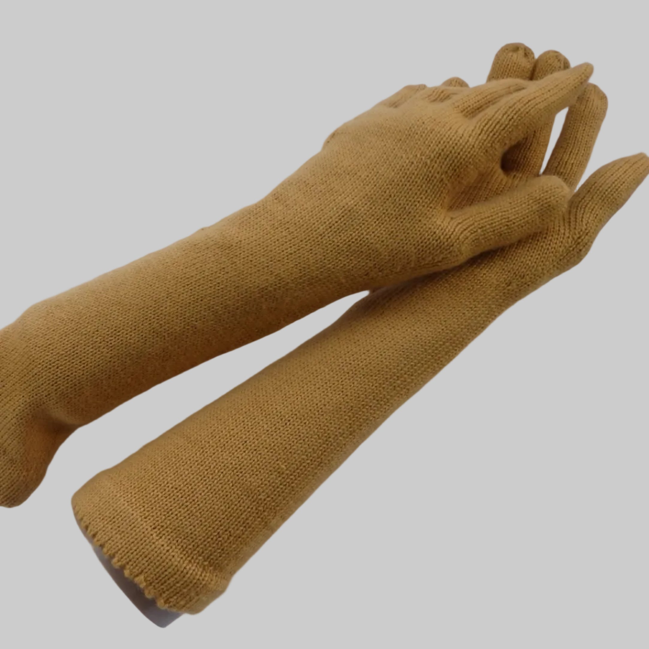 Pair of mustard yellow gloves on a white background