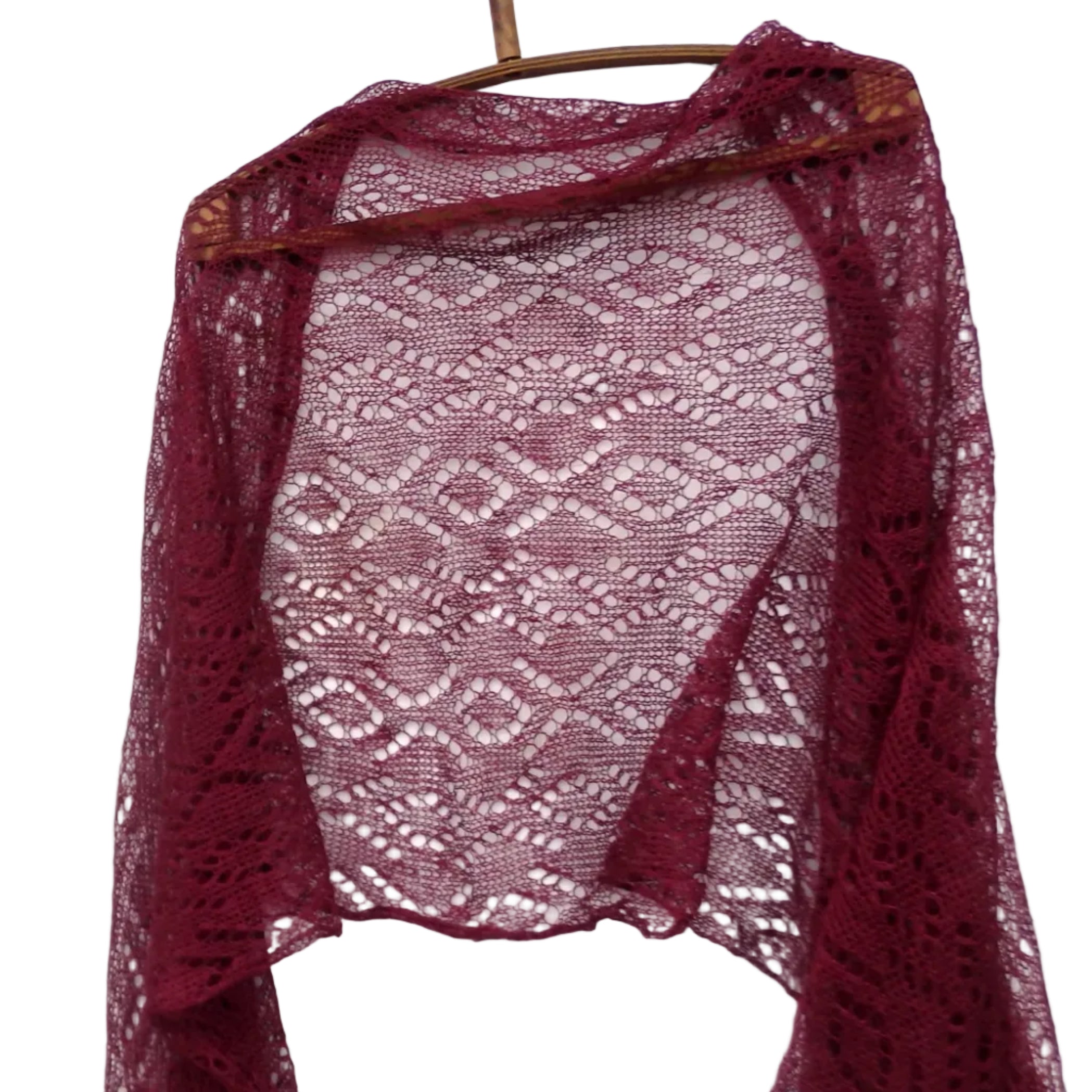 Maroon lace shawl on a wooden hanger against a white background