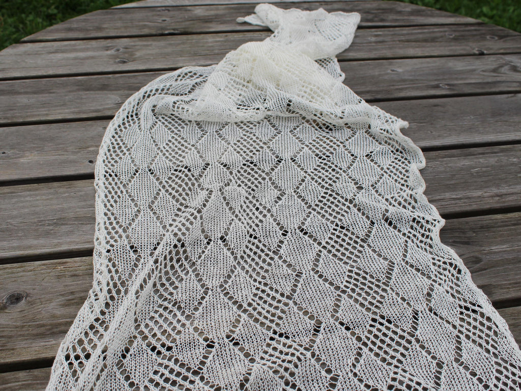 Knitted lace shawl on a wooden surface
