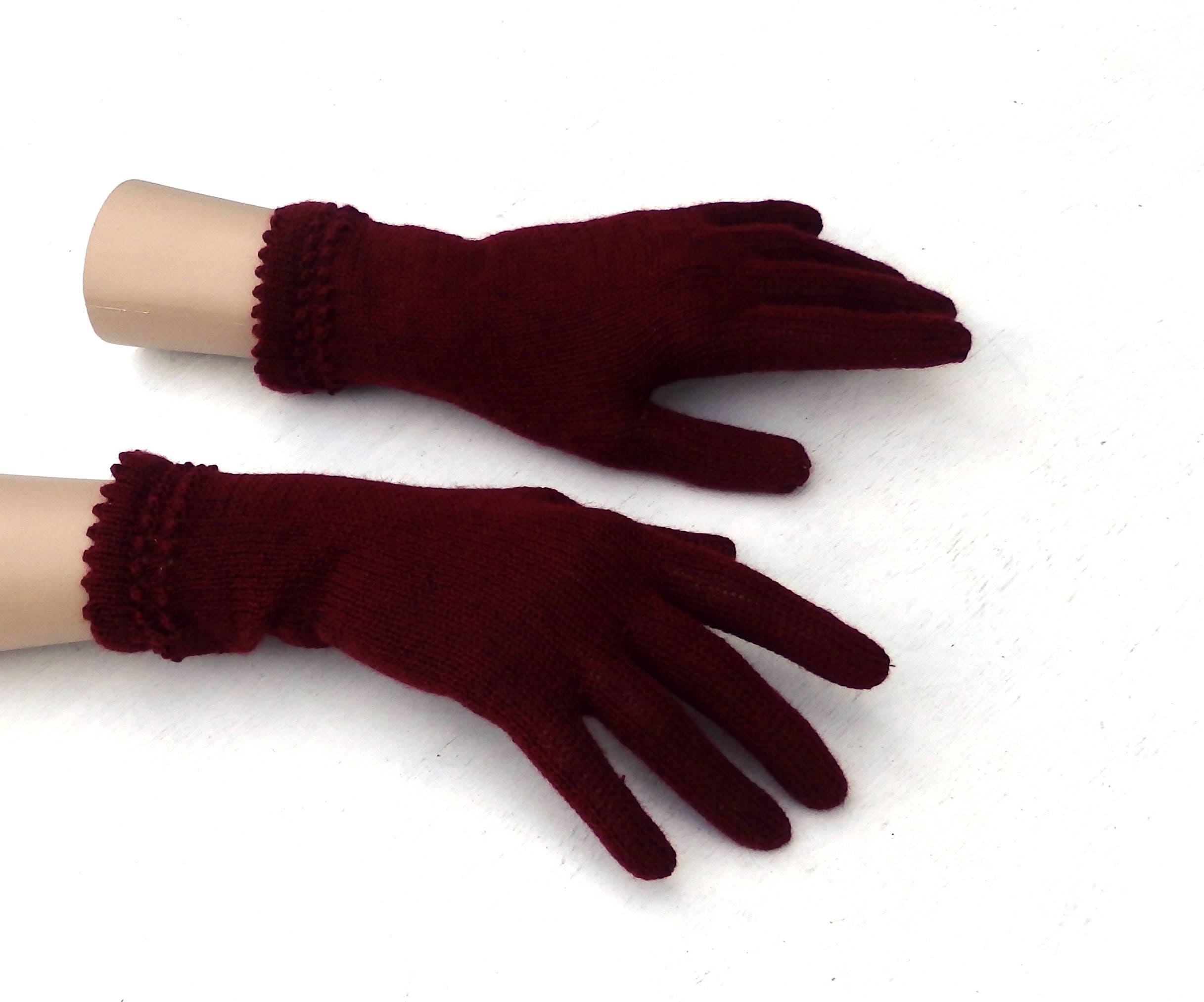 Pair of maroon gloves on a white background