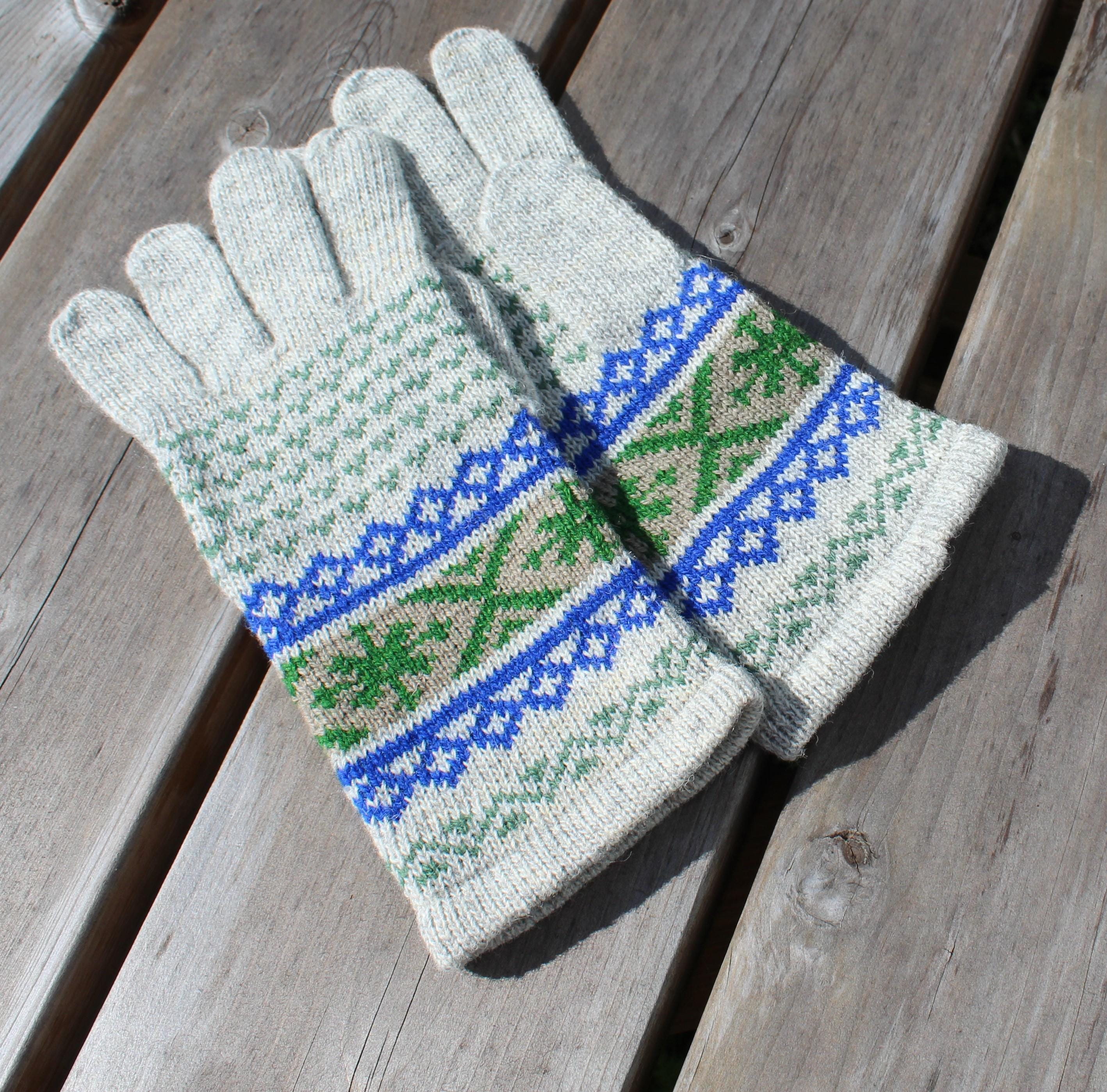 Pair of knitted gloves with a pattern on a wooden surface