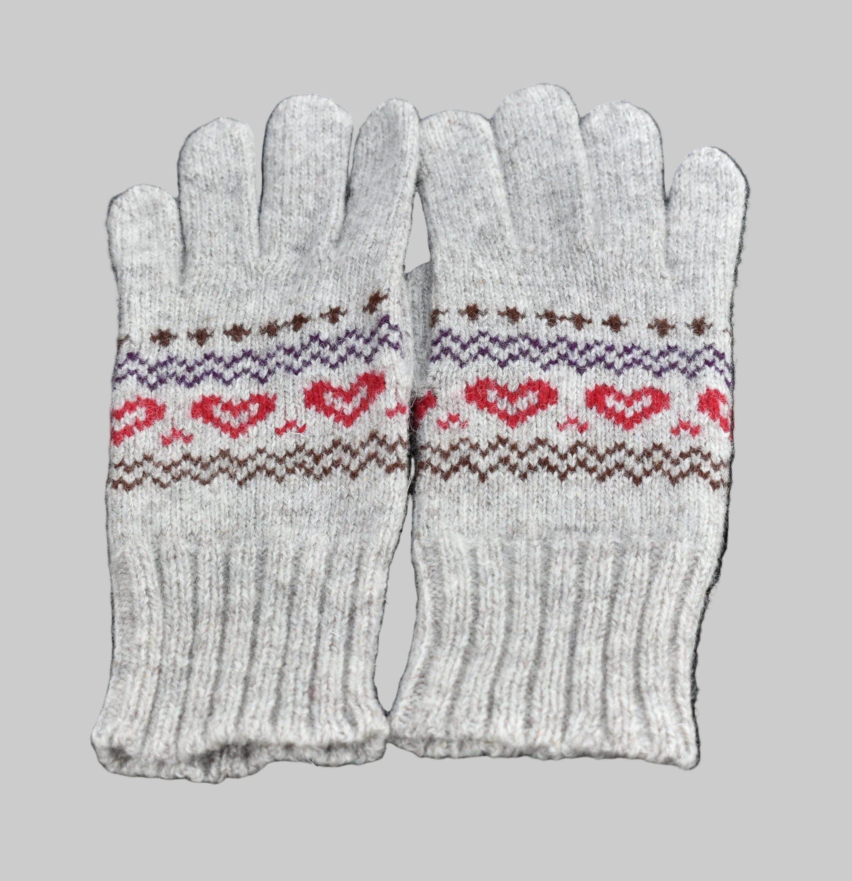 Pair of gray gloves with heart pattern on a black background
