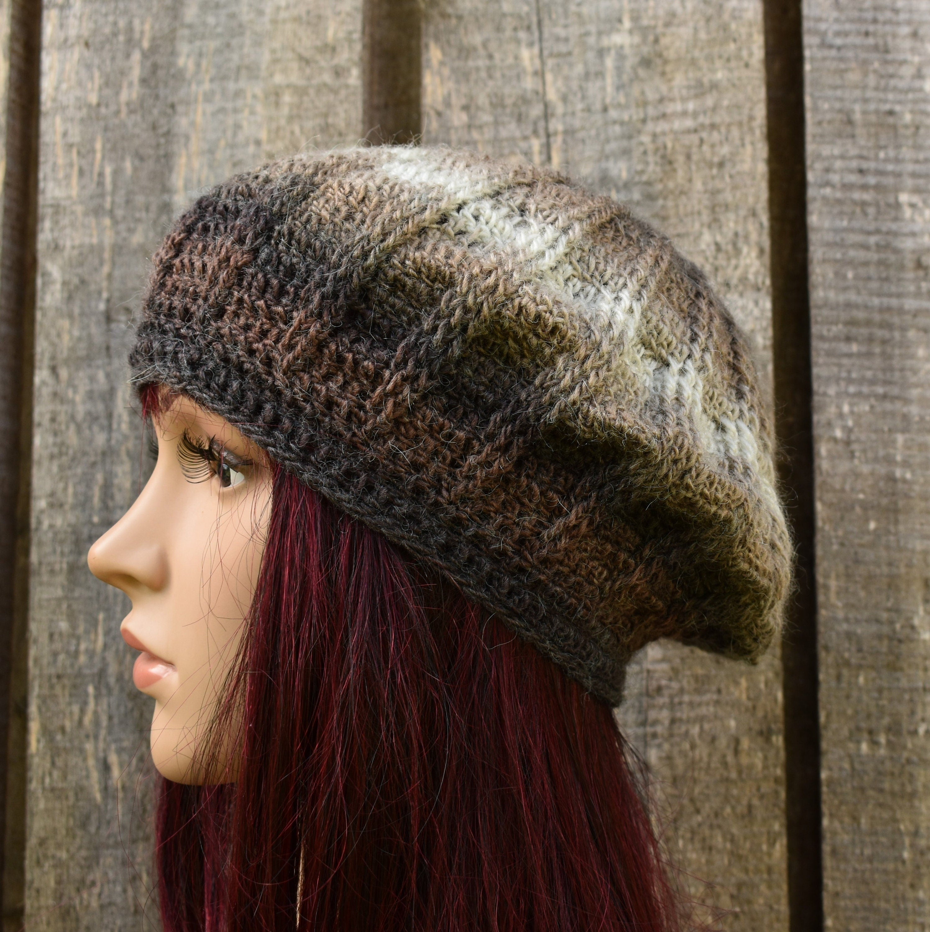 Woman wearing a patterned knit hat against a wooden background