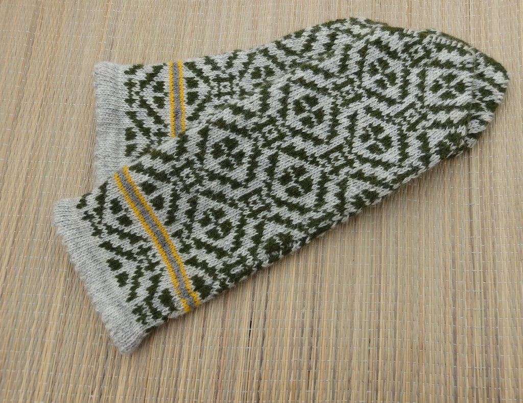 Knitted glove with a geometric pattern on a wooden surface