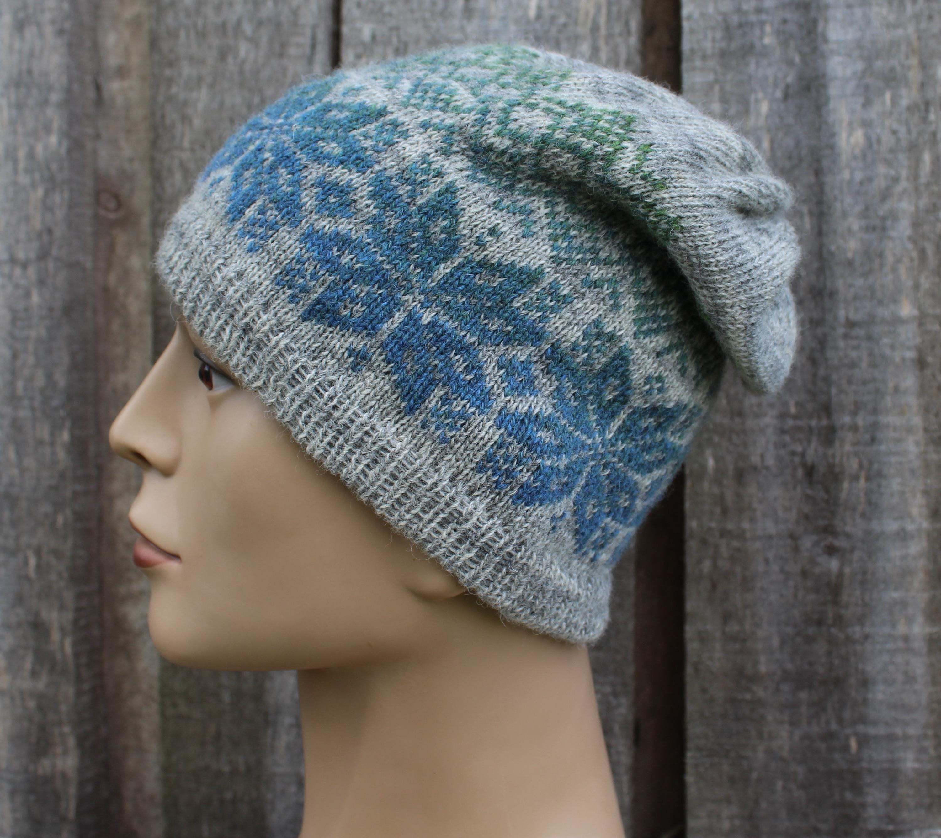 Knitted hat with a pattern on a mannequin head against a wooden background