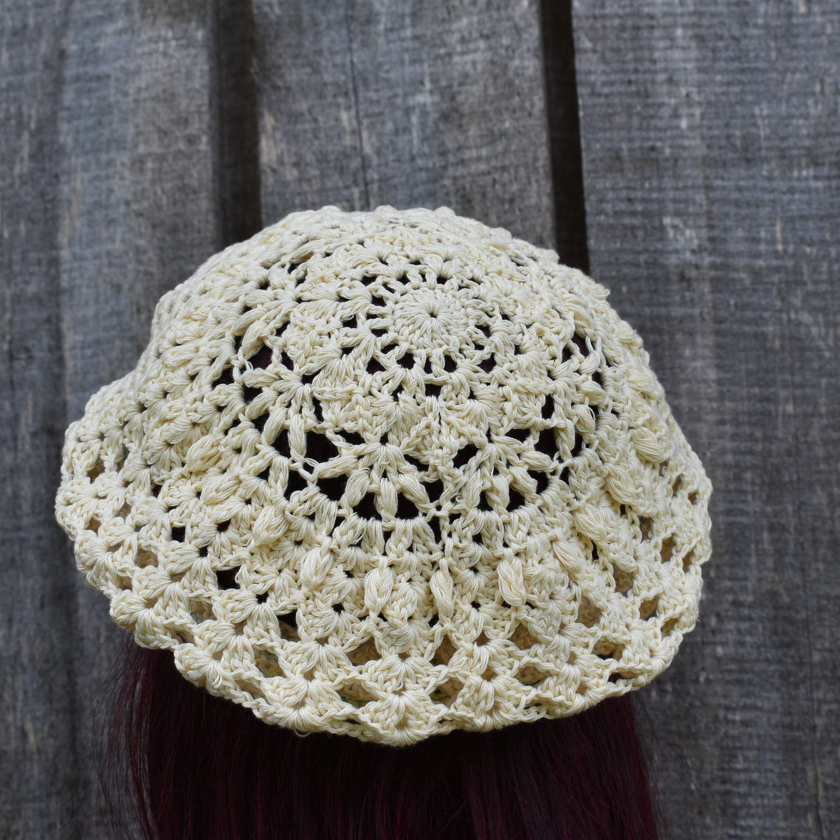 Crocheted beige hat on a dark background