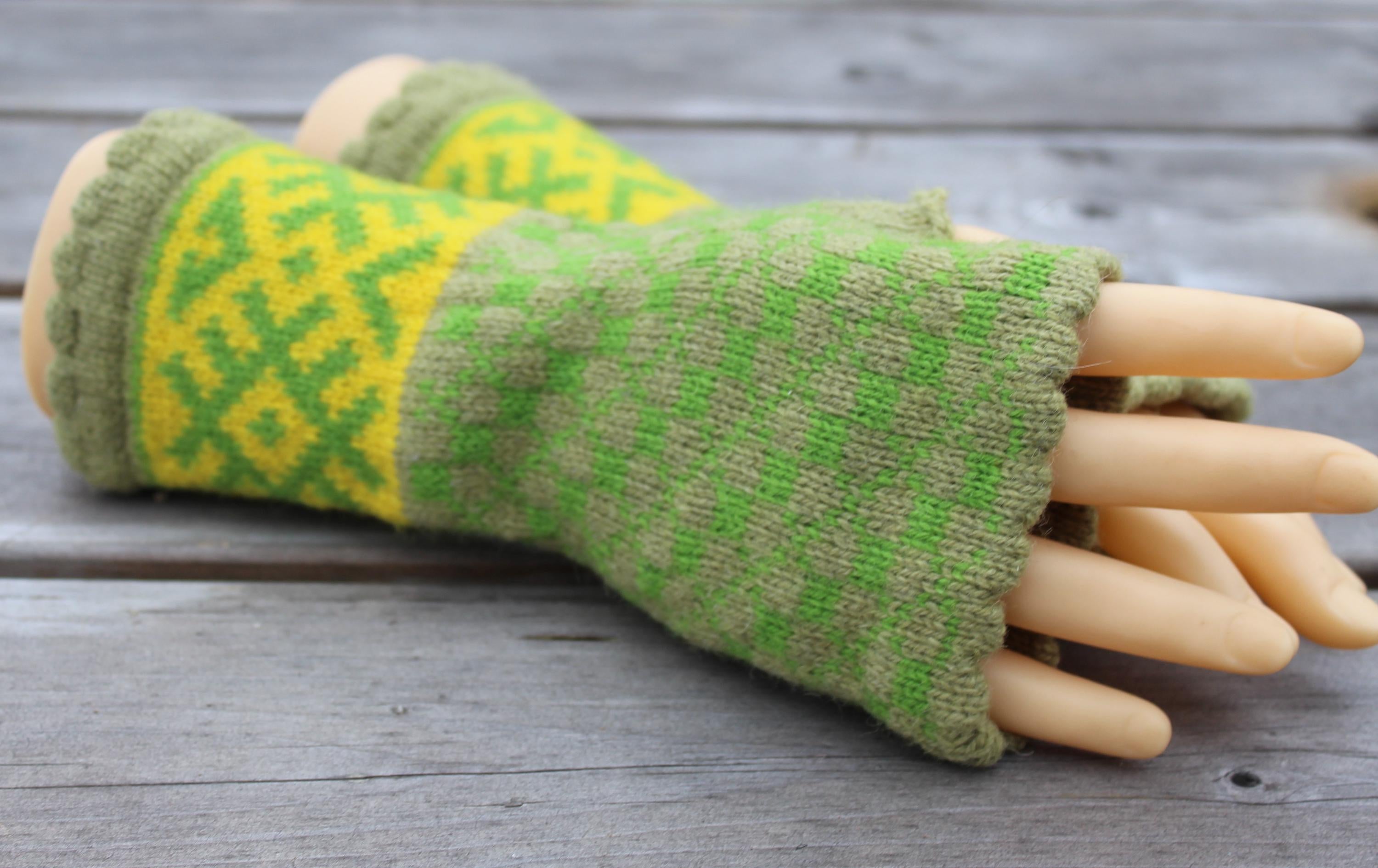 Green and yellow patterned fingerless gloves on a wooden surface