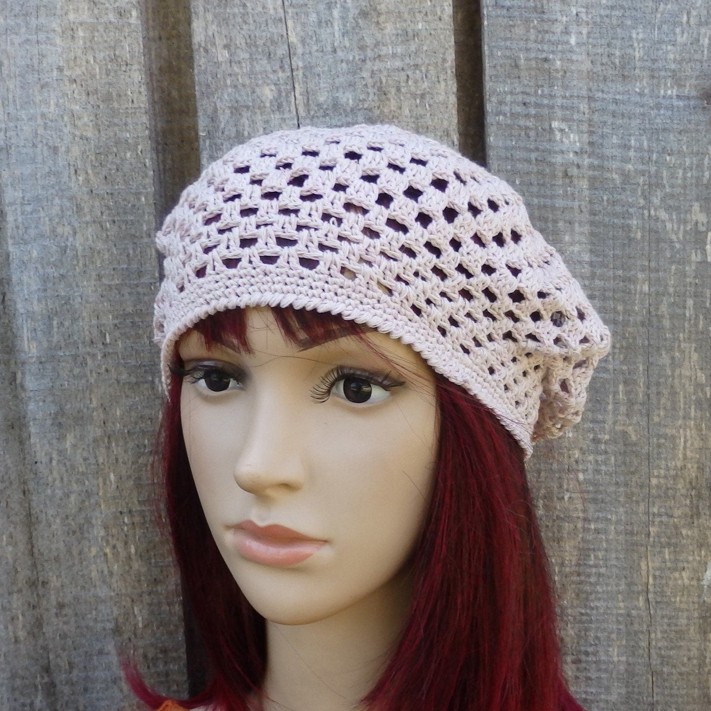 Mannequin head wearing a light pink crochet cotton  hat 