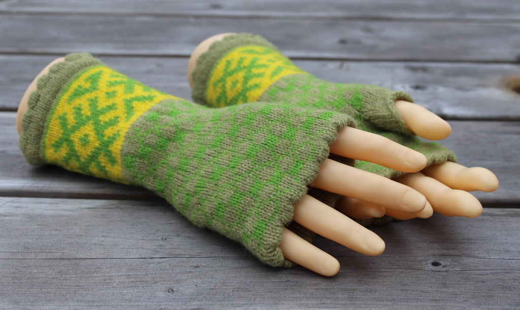 Green and yellow patterned fingerless gloves on a wooden surface