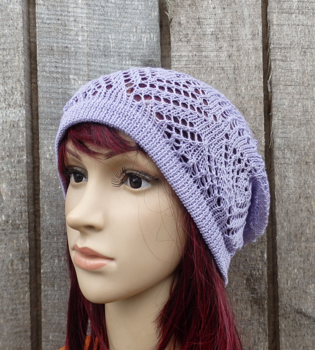 Lace purple beanie on a mannequin head against a wooden background