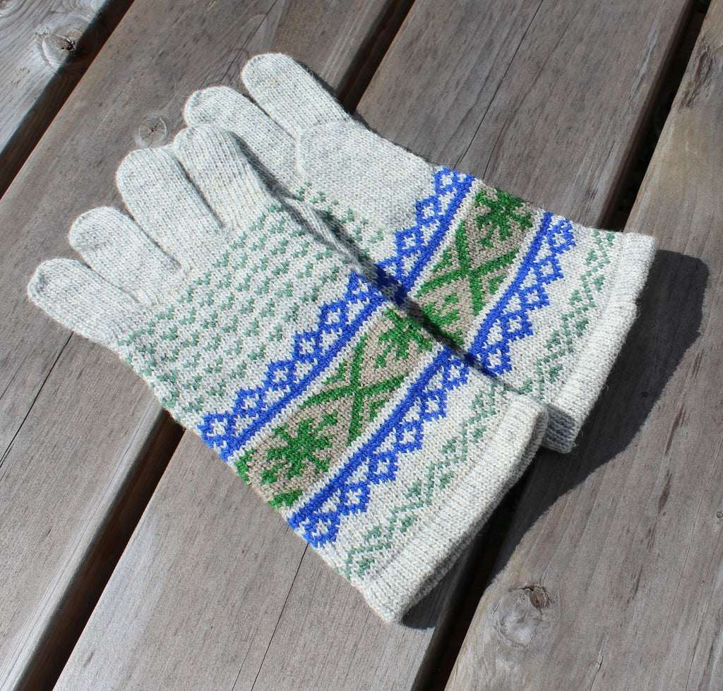 Pair of knitted gloves with a geometric pattern on a wooden surface