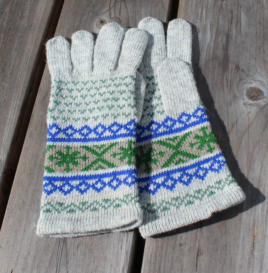 Pair of knitted gloves with a pattern on a wooden surface