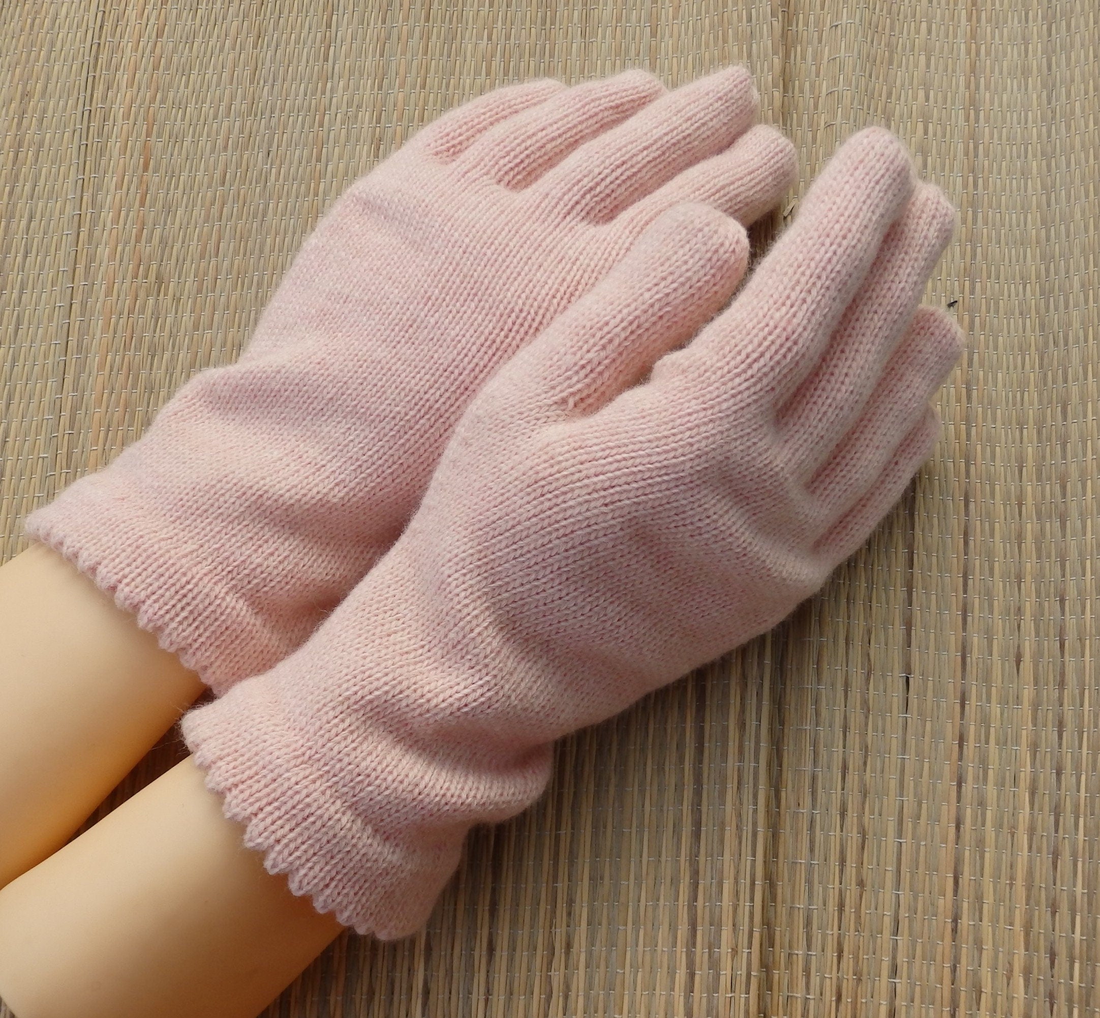 Pink gloves on a wooden surface