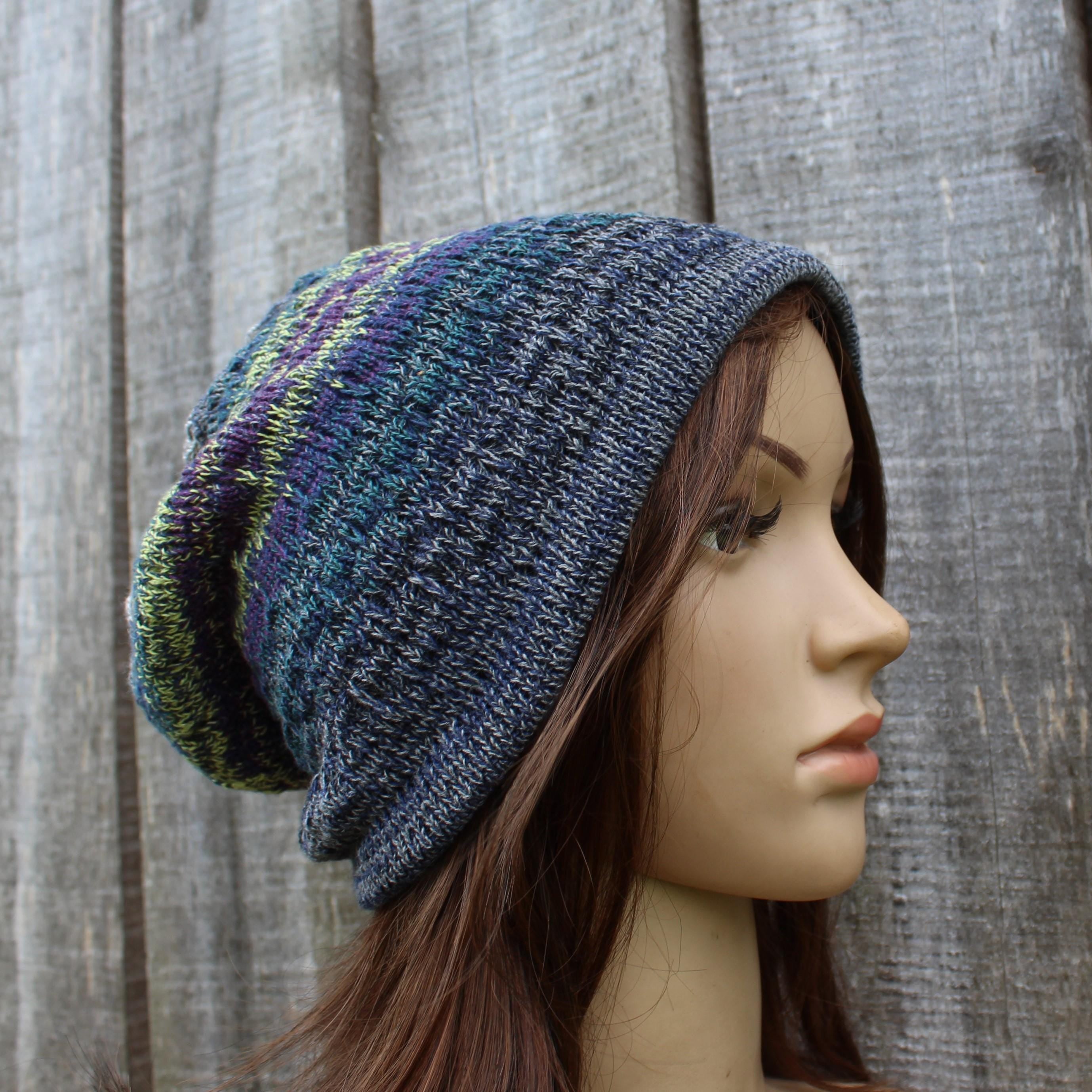 Knitted beanie on a mannequin head against a wooden background