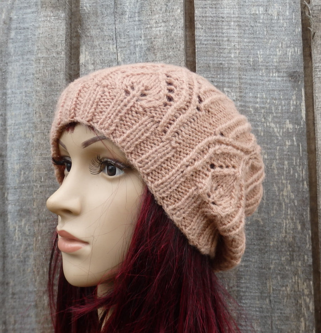 Knitted beige beanie on a mannequin head against a wooden background