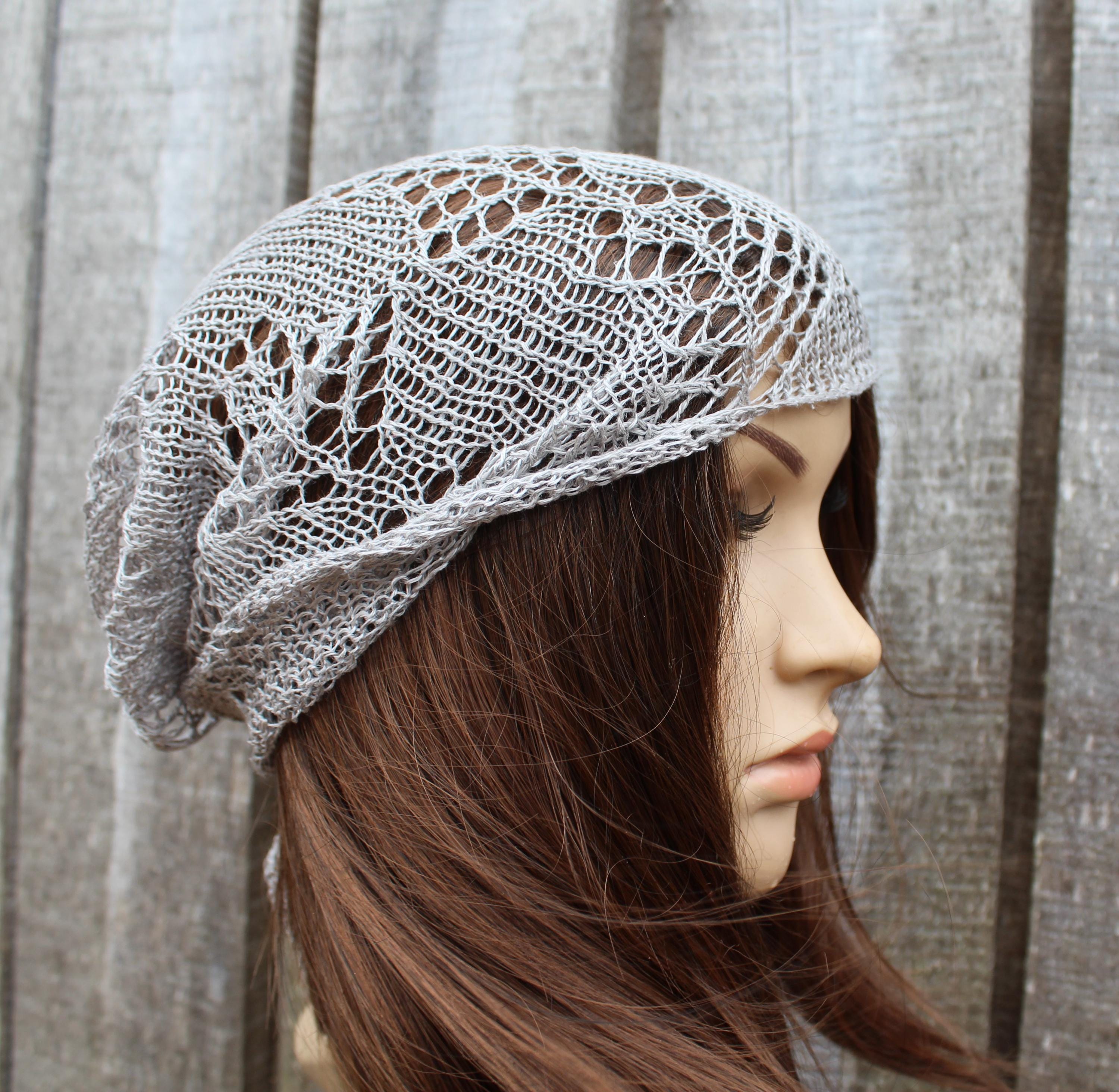 Knitted lace headband on a mannequin head with a neutral background