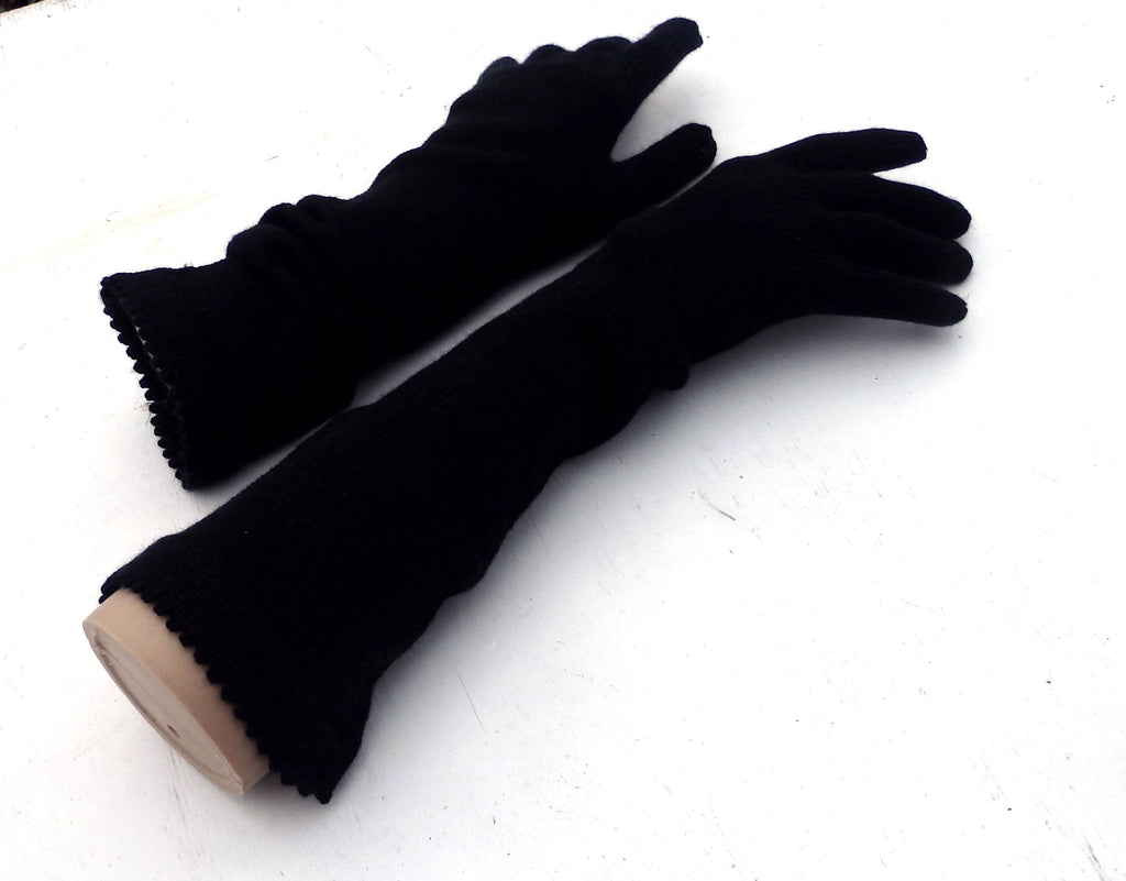 Pair of black gloves on a white background