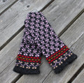 Knitted scarf with a colorful pattern on a wooden surface