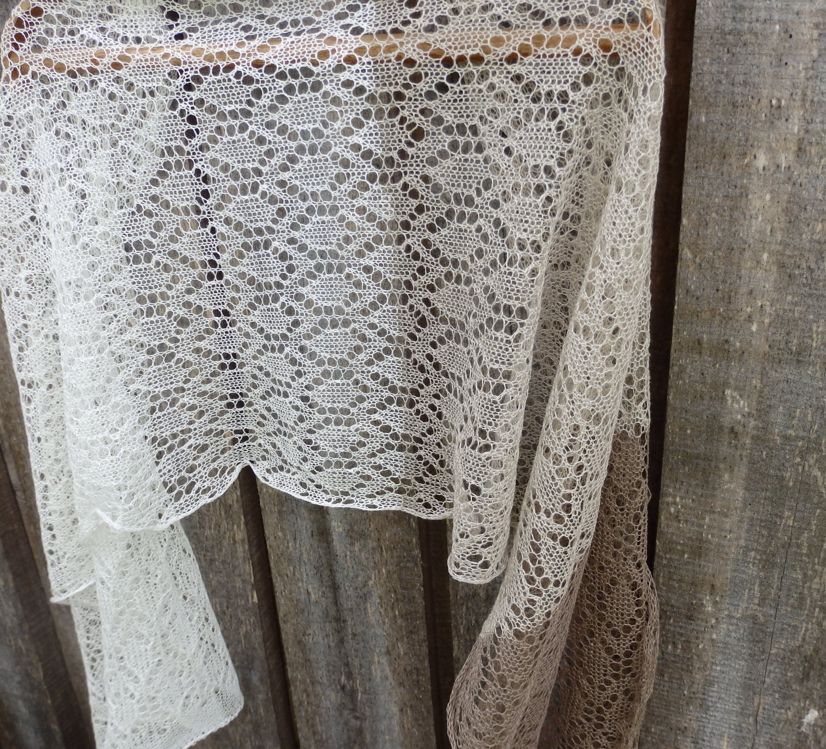White lace fabric draped over a wooden surface