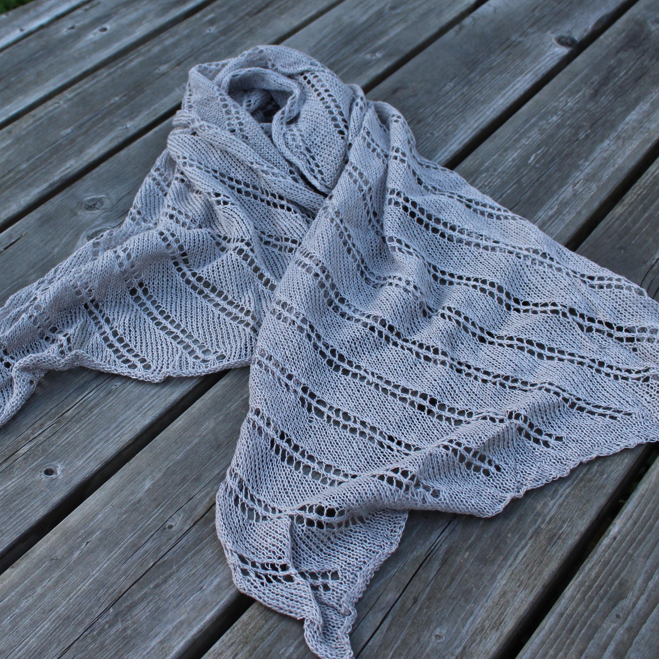 Knitted shawl on a wooden surface