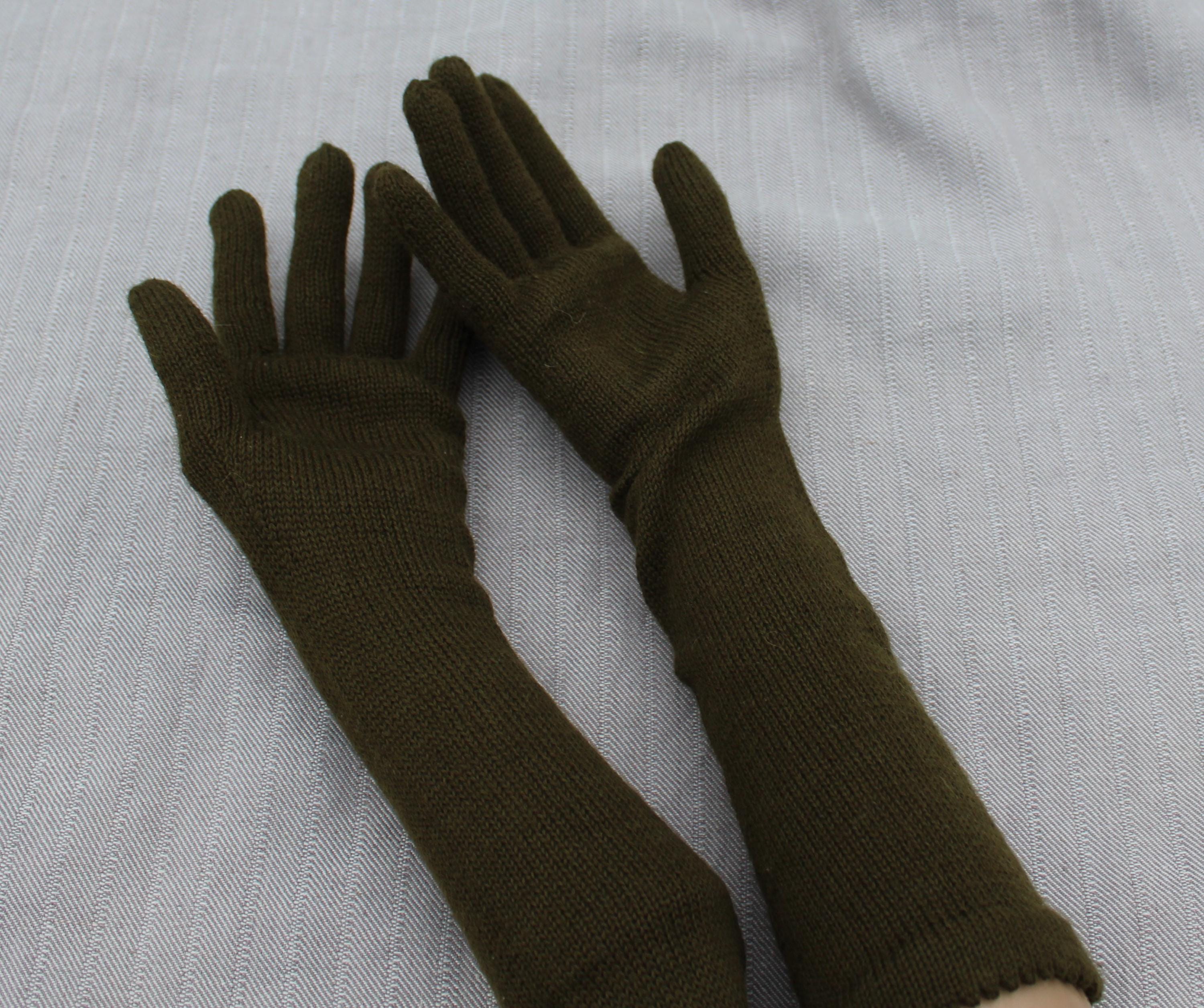 Pair of brown gloves on a light gray background