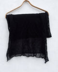 Black scarf on a wooden hanger against a white background